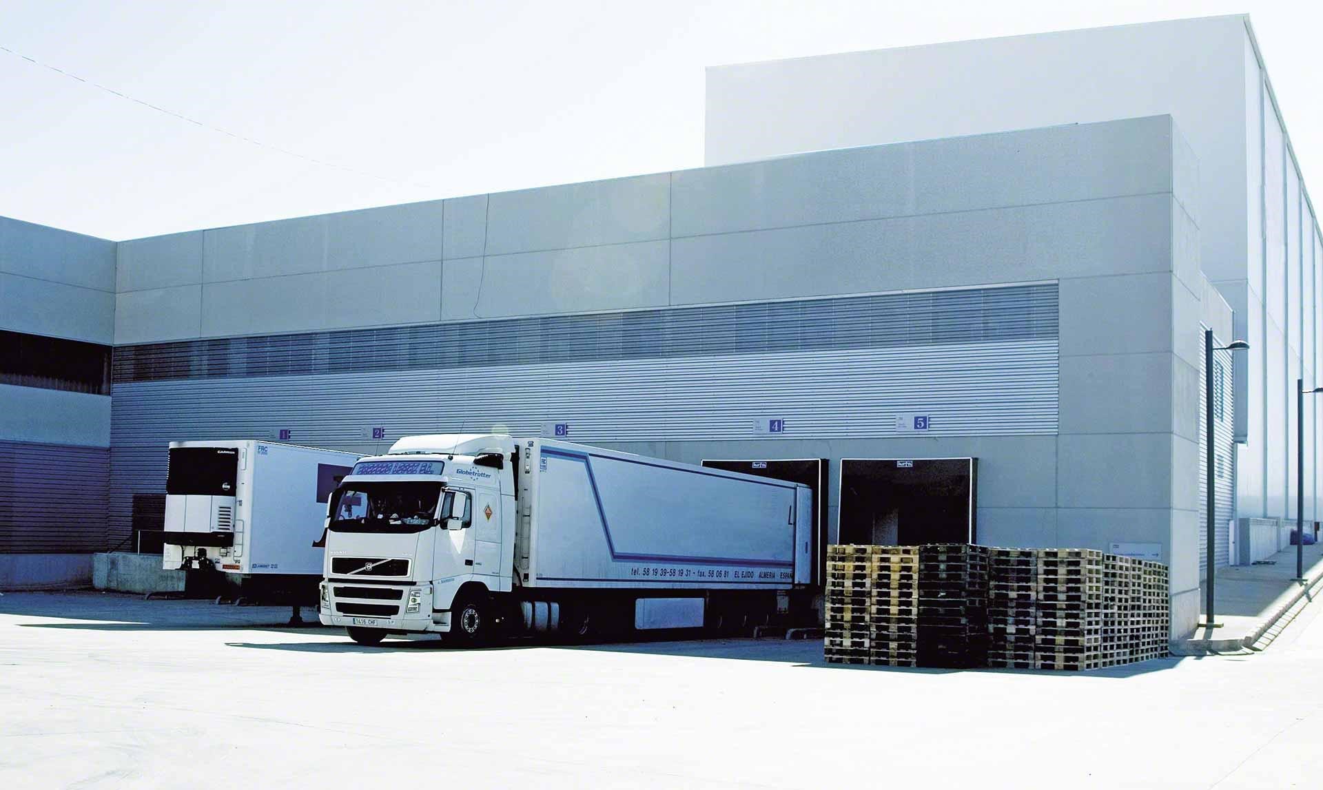 Lorries unload goods in the warehouse as part of cross-docking operations